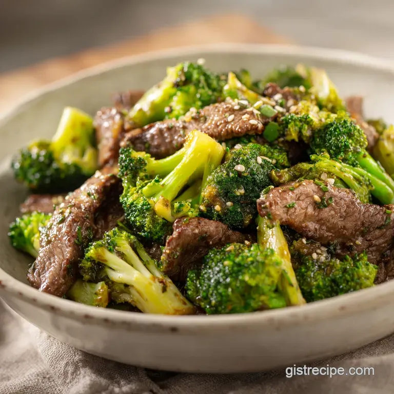 Perfectly plated beef and broccoli, steam rising, garnished with sesame seeds and sliced scallions on white rice.