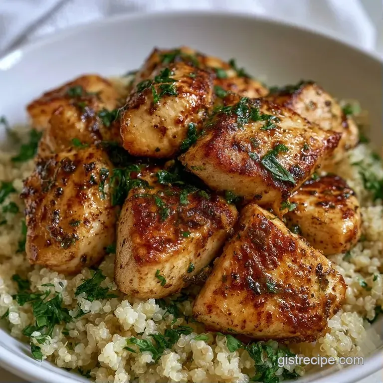 Sliced grilled chicken atop fluffy quinoa, accented by creamy avocado slices and a sprinkle of toasted sesame seeds.