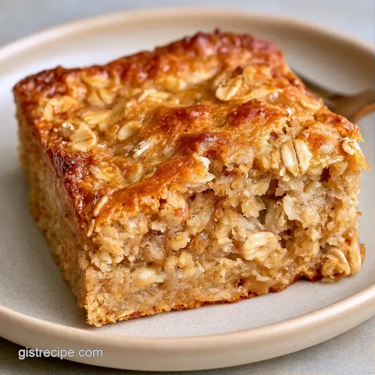 Stacked oat-based bars on a white ceramic plate, garnished with fresh banana coins and a drizzle of honey.