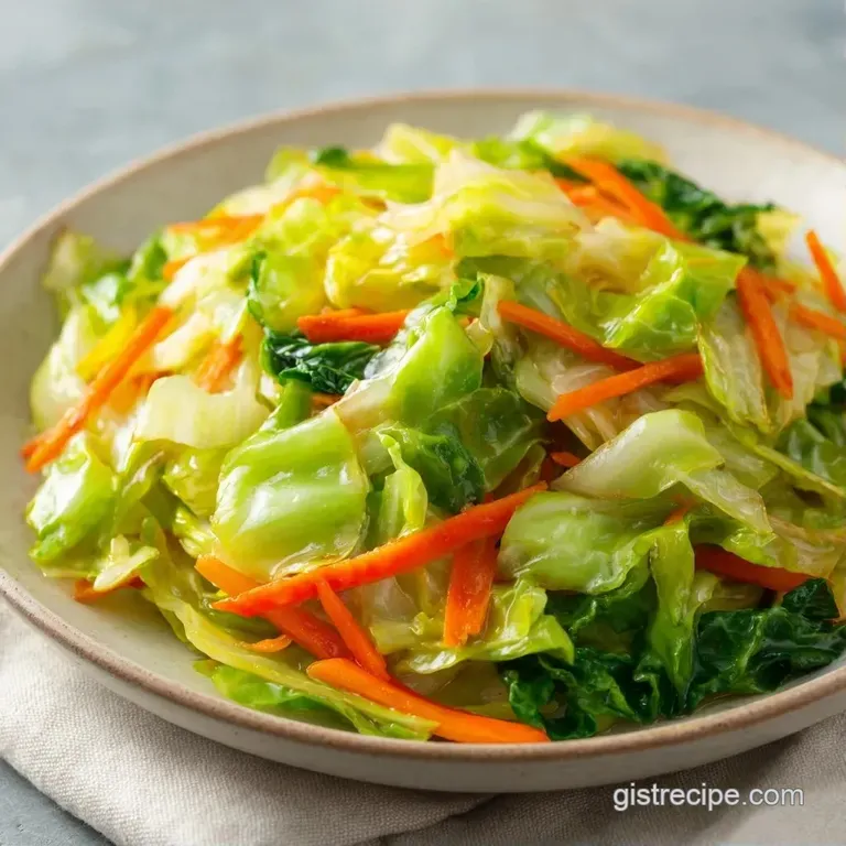 Vibrant green and purple cabbage ribbons piled high in a white ceramic bowl, topped with toasted sesame seeds.