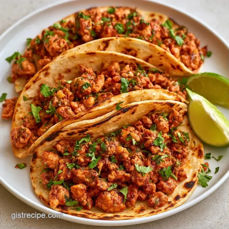 Three colorful tacos arranged on a white platter with side bowls of zesty lime wedges and fresh cilantro leaves.