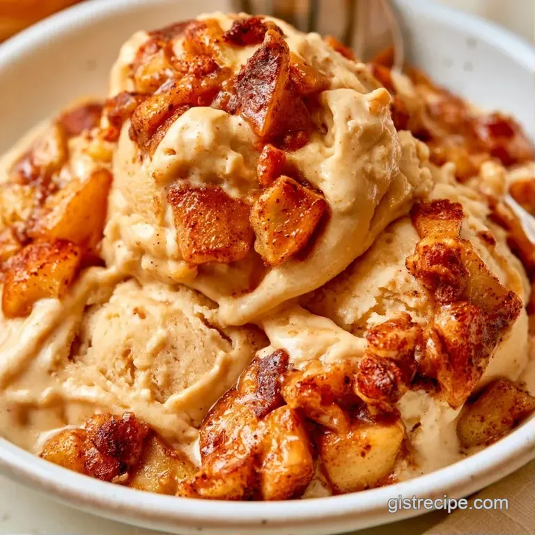 Two pale scoops of frozen dessert in a glass bowl, garnished with glazed fruit and a sprinkle of cinnamon powder.