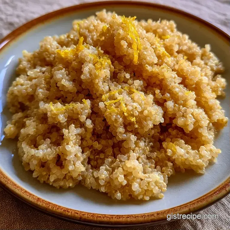 Vibrant grains arranged in a white bowl with creamy feta crumbles, bright herbs, and a wedge of yellow lemon.