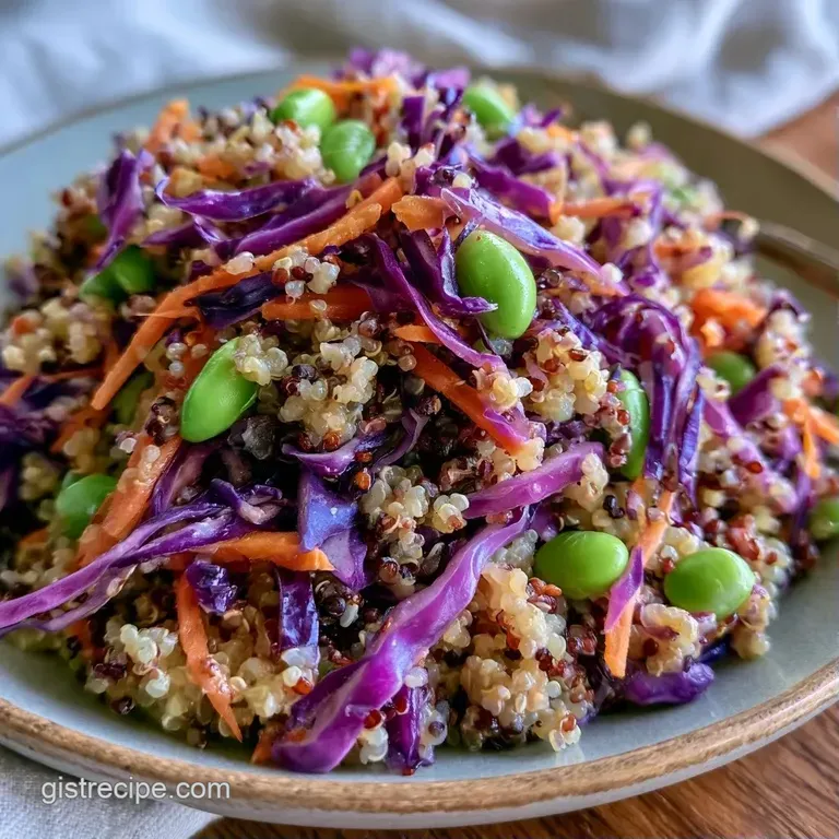 Colorful array of steamed vegetables and quinoa in a ceramic bowl, topped with crushed peanuts and fresh cilantro.
