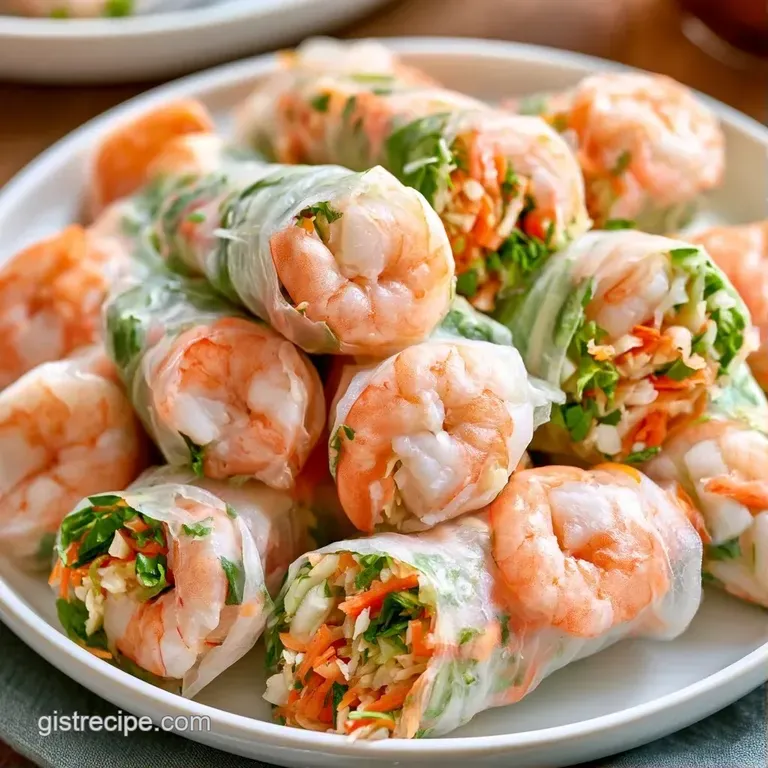 Neatly sliced translucent wraps arranged in a row next to a small bowl of amber-colored peanut dipping sauce.